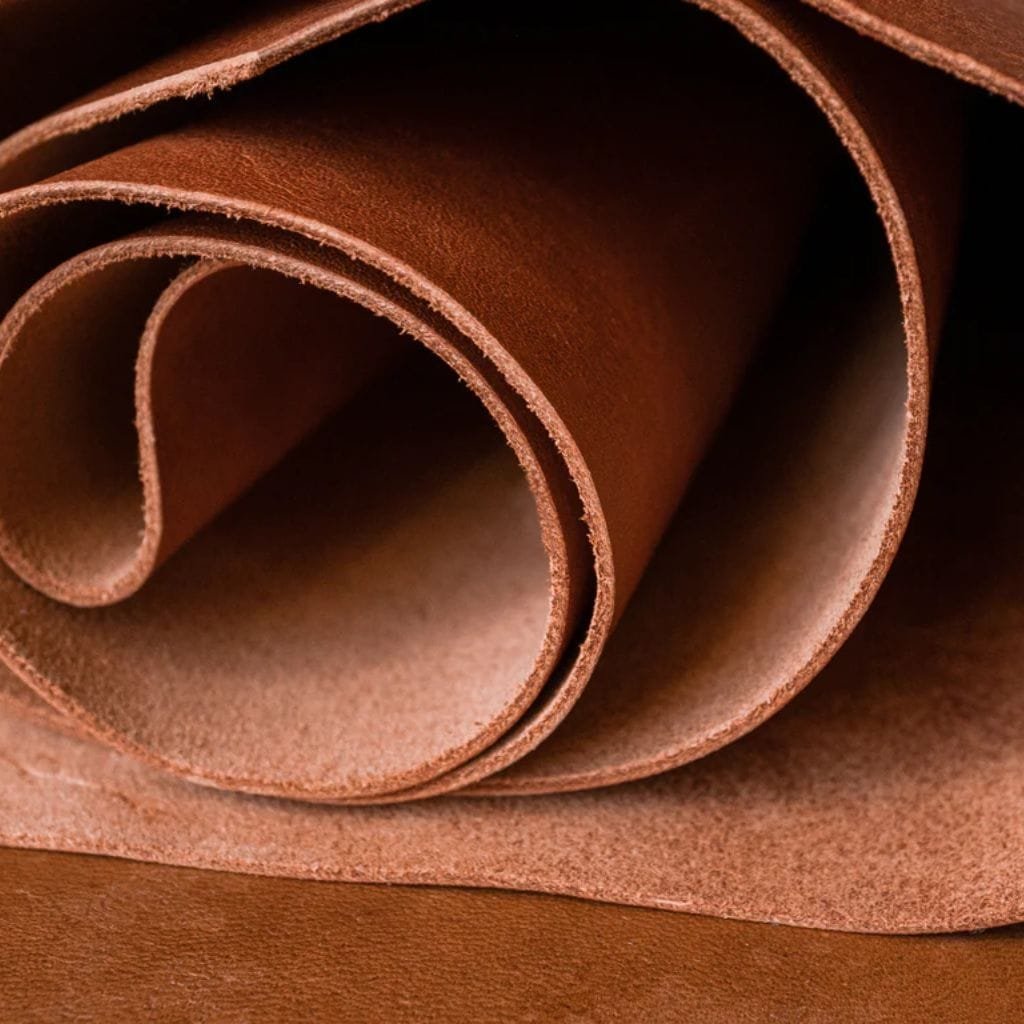 Chrome-Tanned Leather – Luxuriously Soft, Long-Lasting & Vibrant. Rolled sheets of chrome-tanned leather displaying a smooth, flexible texture with a rich finish.