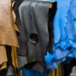 Different shades of leather hides, including brown, black, and blue, showcasing the future of the leather industry.