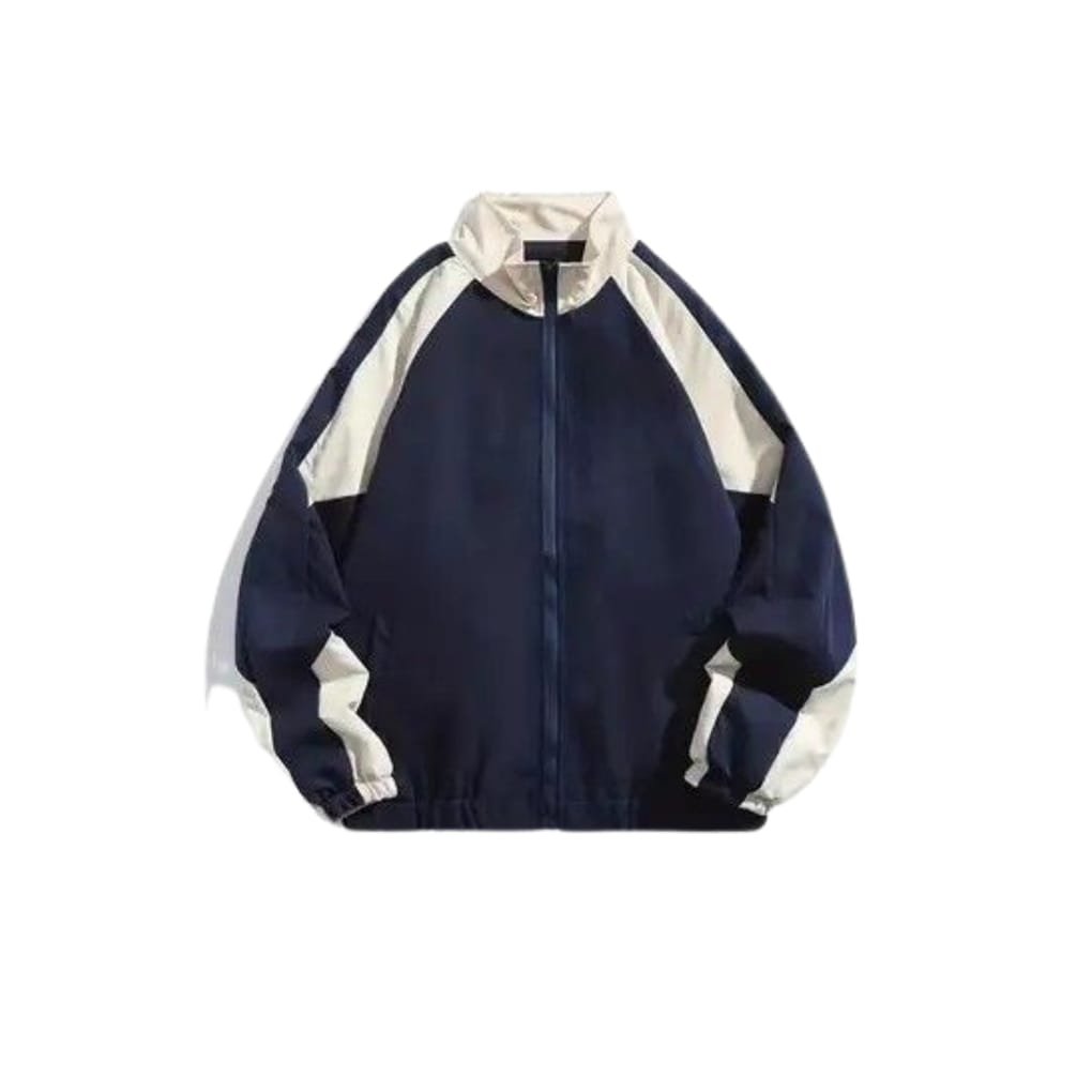 A navy blue jacket with cream-colored raglan sleeves, featuring a high collar and a front zipper.