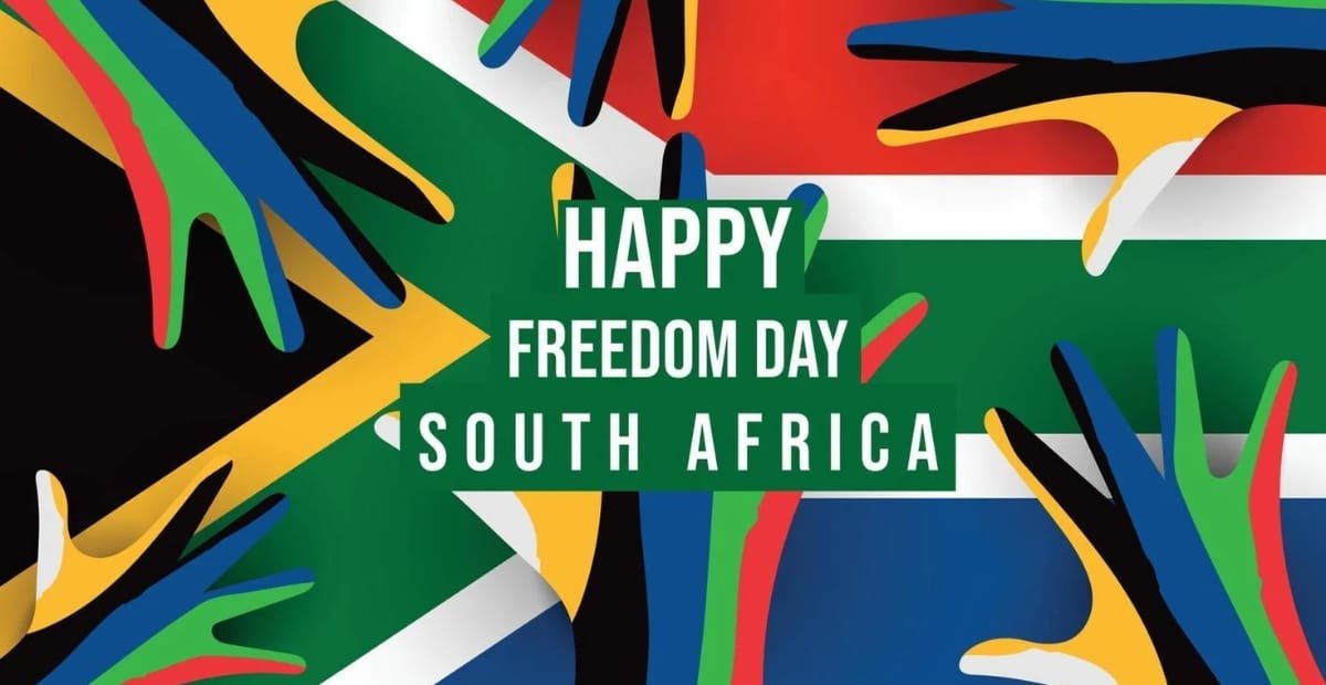 An illustration featuring colorful hands against a backdrop of the South African flag with the text "Happy Freedom Day South Africa."