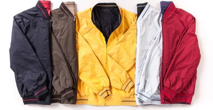 A collection of five colorful jackets arranged side by side, featuring a navy blue, army green, bright yellow, light blue, and burgundy jacket, all with elastic cuffs and varying collar styles. best jackets for 40° weather