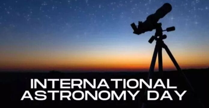 Silhouette of a telescope pointing at a starry sky during sunset or dusk, with the text 