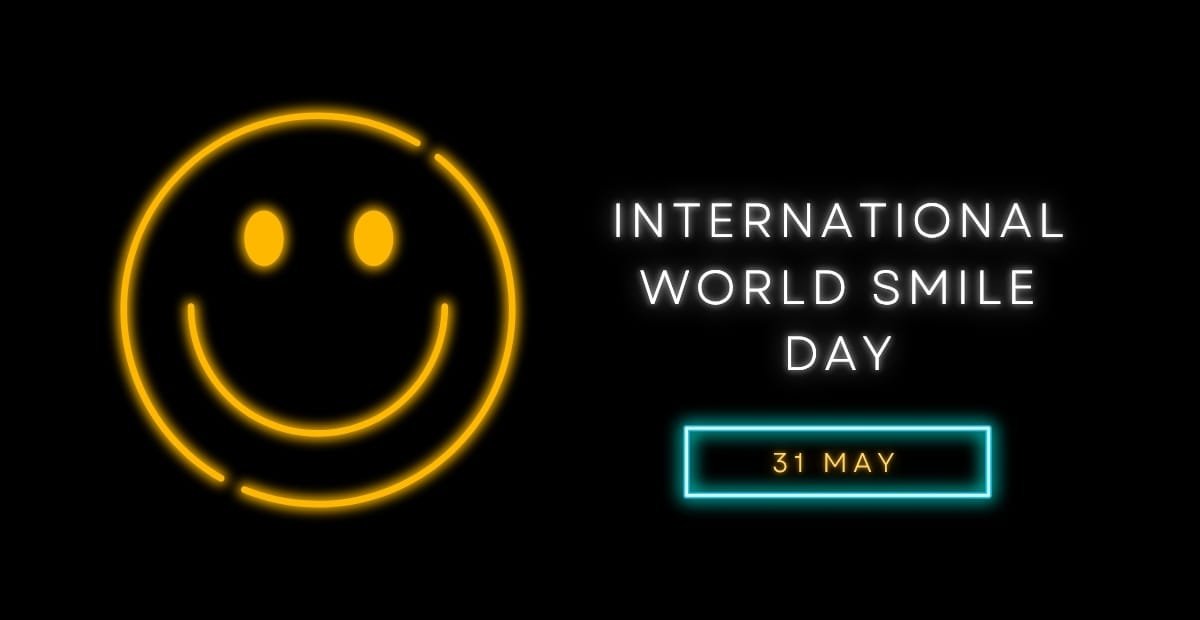 National Smile Day – Why Smiling Matters More Than You Think Neon smiley face with the words “International World Smile Day – 31 May” on a black background.
