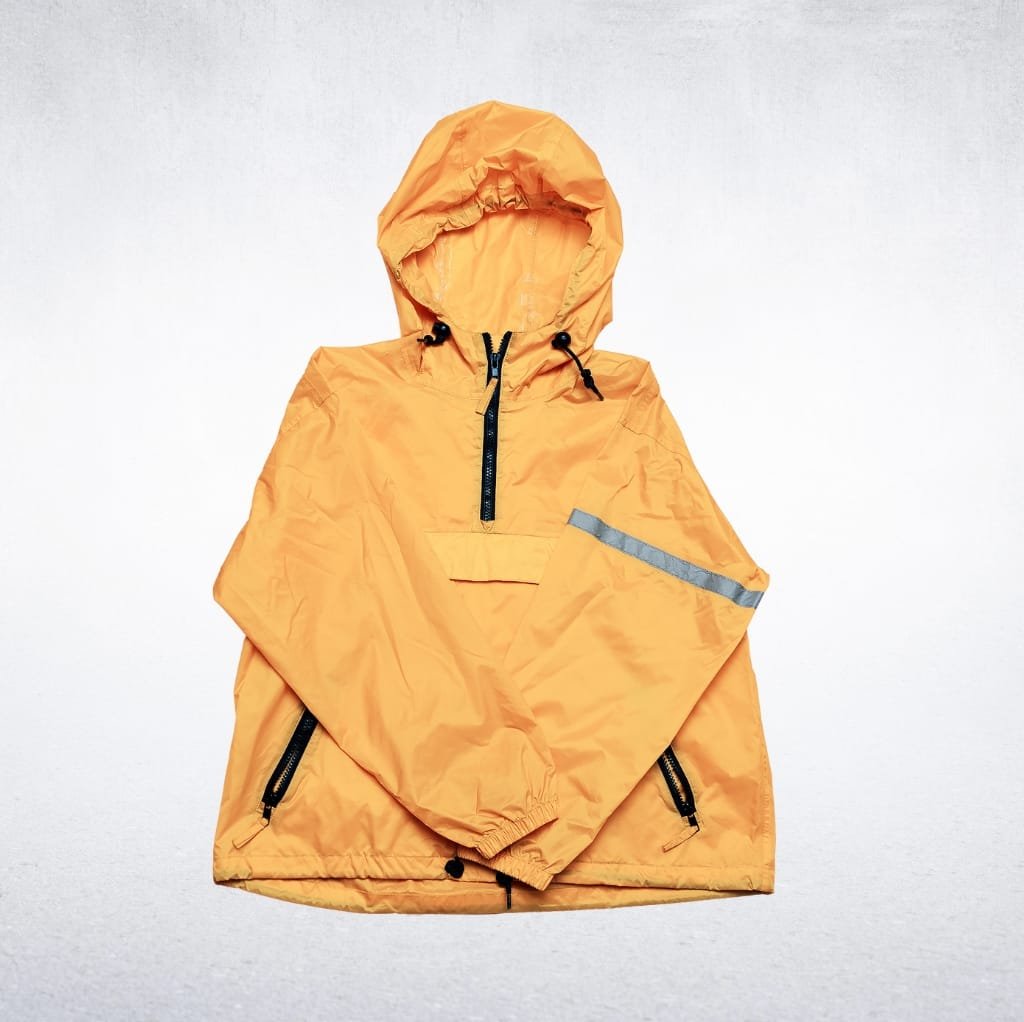 A bright orange, waterproof lined workwear jacket with a hood, zipper pockets, and reflective strip on the sleeve, laid flat on a light-colored surface.