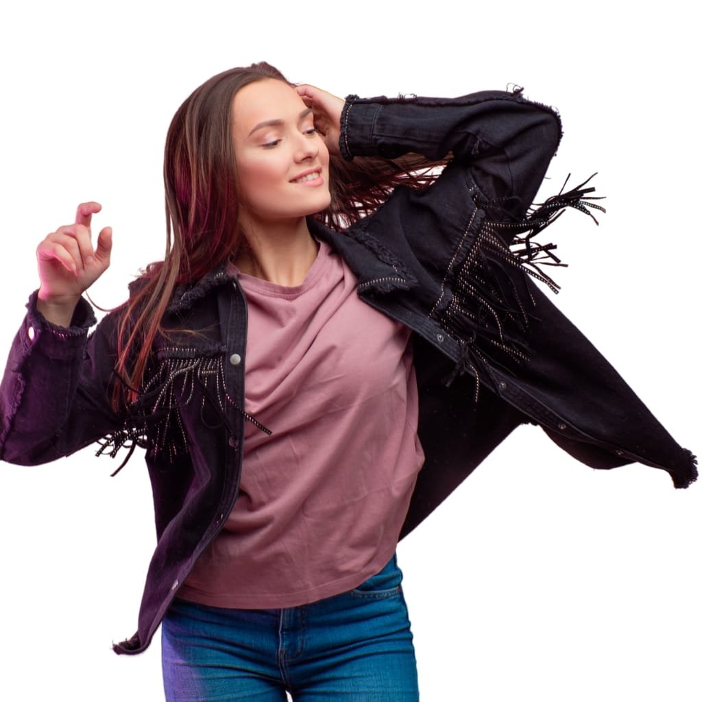 Woman dancing at a music festival wearing a tan suede fringe jacket with a floral dress and boots.