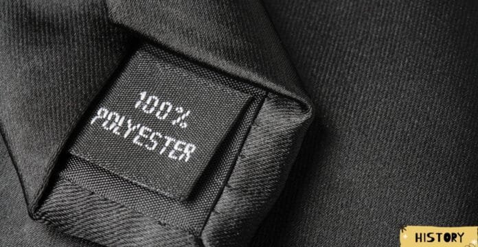 Close-up of a black fabric label on a garment, with white text reading 