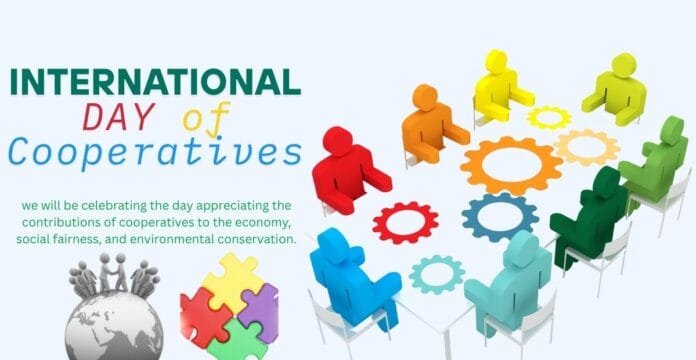 A colorful illustration celebrating International Day of Cooperatives, depicting ten diverse stylized human figures sitting around a circular table with interconnected gears in the center, symbols of collaboration and teamwork. There is also an image of a globe with small figures standing on top and interlocking puzzle pieces.