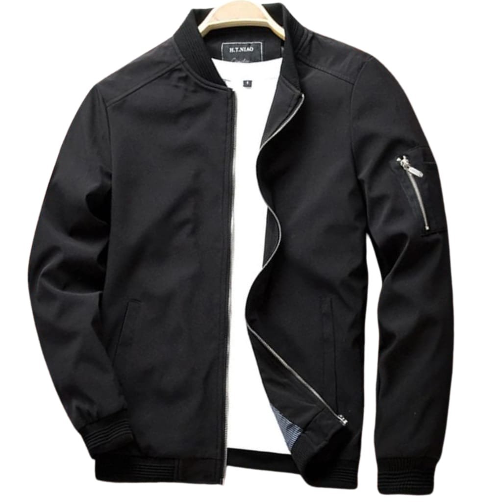 Black zip-up bomber jacket with ribbed cuffs and waistband, featuring a zippered pocket on the sleeve, hanging on a hanger against a plain background.

