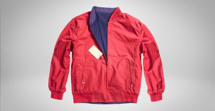 A model wearing an oversized bomber jacket in olive green with ribbed cuffs and hem, paired with casual jeans.