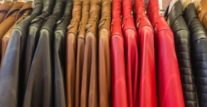 A row of leather jackets hanging on a rack, showcasing various colors including black, brown, and red.