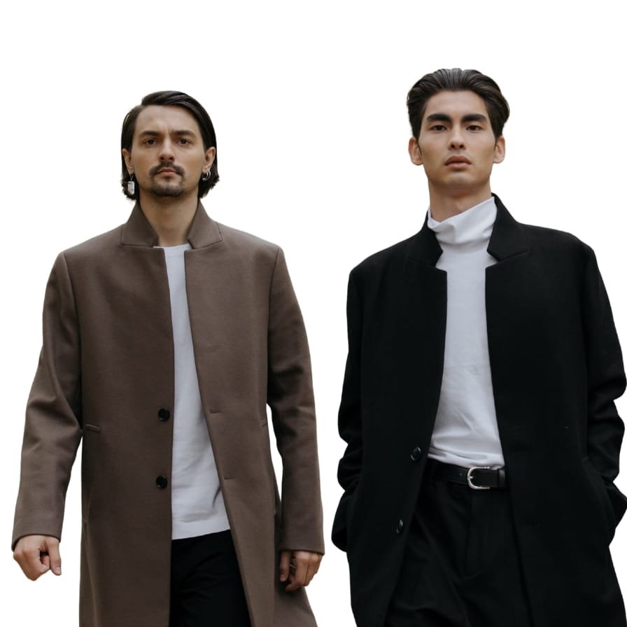 Two men standing side by side, each wearing a stylish topcoat; the man on the left in a brown topcoat and the man on the right in a black topcoat, both against a plain white background.


