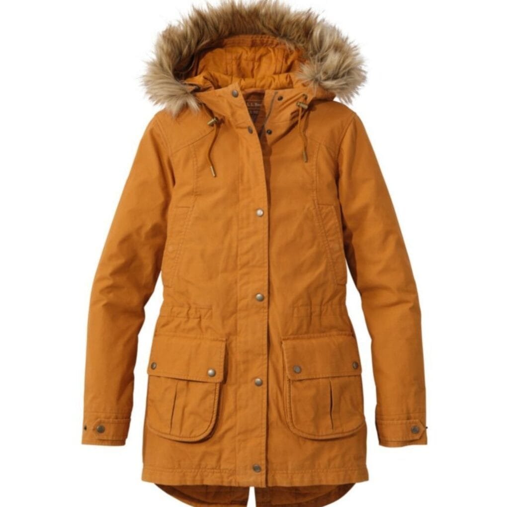 A long, orange winter parka jacket with a faux fur-lined hood, multiple front pockets, and metallic buttons and zippers.