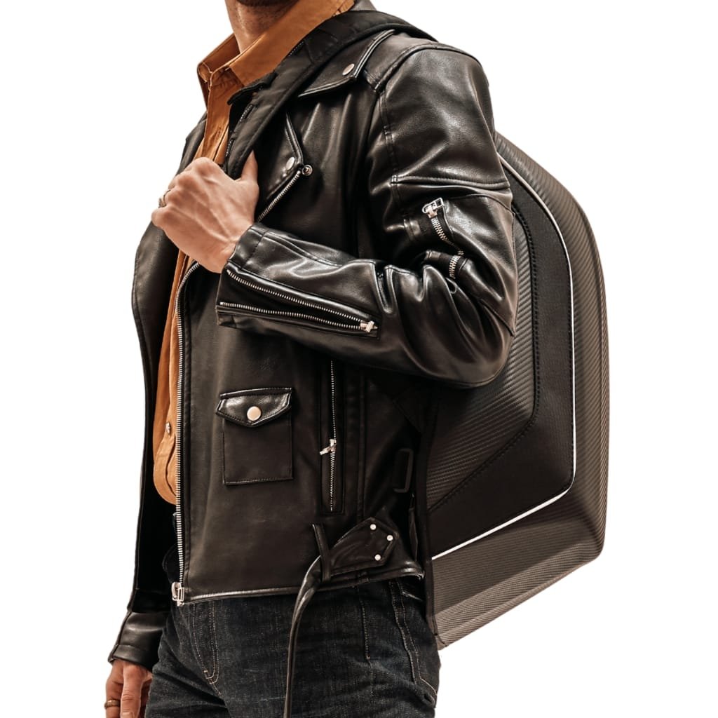 A person wearing a black leather jacket over a brown shirt, carrying a black backpack.