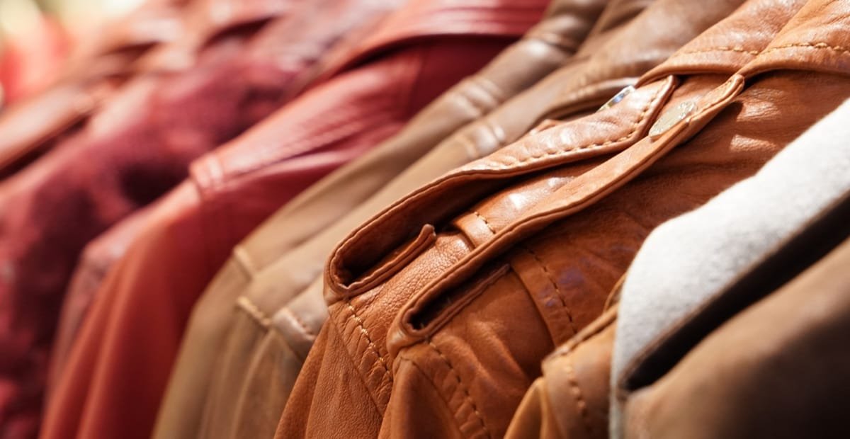 What Is a Leather Jacket? A Timeless Icon of Style and Attitude Close-up of several leather jackets hanging on a rack, showcasing various shades of brown and tan.