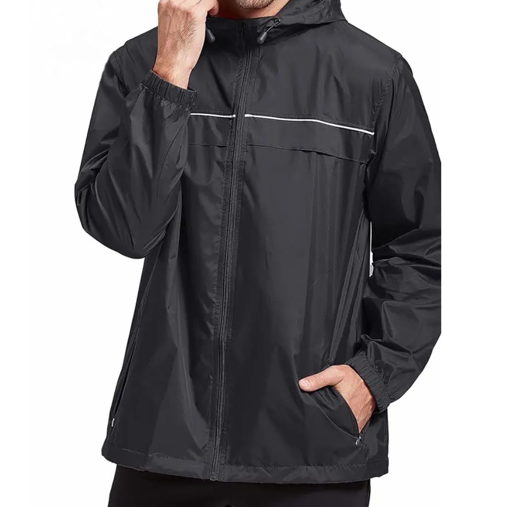 A man wearing a black windbreaker jacket with a hood, standing with one hand in the pocket, against a plain background.

