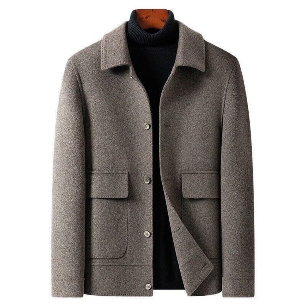 A stylish men's wool jacket in a neutral gray color, featuring a classic collar, four front pockets, and button closure, paired with a black turtleneck underneath.