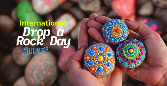 Colorfully painted rocks with intricate dot patterns held in two hands, with a background of other painted stones.
