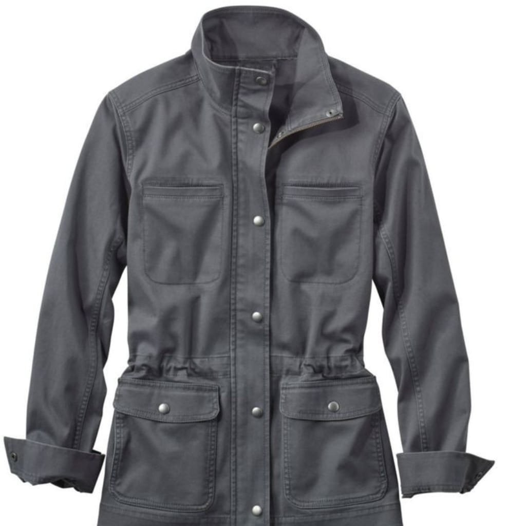 Functional ladies utility jacket in olive green with multiple pockets, zip front, and drawstring waist.