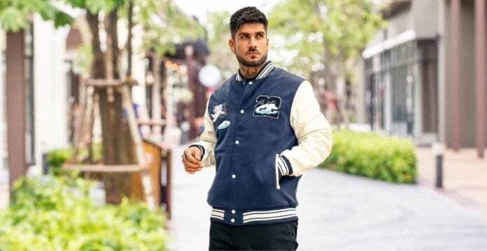 A stylish men's wool varsity jacket featuring a classic design with contrasting sleeves, ribbed collar, cuffs, and hem, with front button closure.