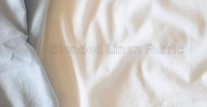 A close-up view of soft, light-colored blended linen fabric with gentle folds and a subtle sheen, showing a pale cream to off-white tone.