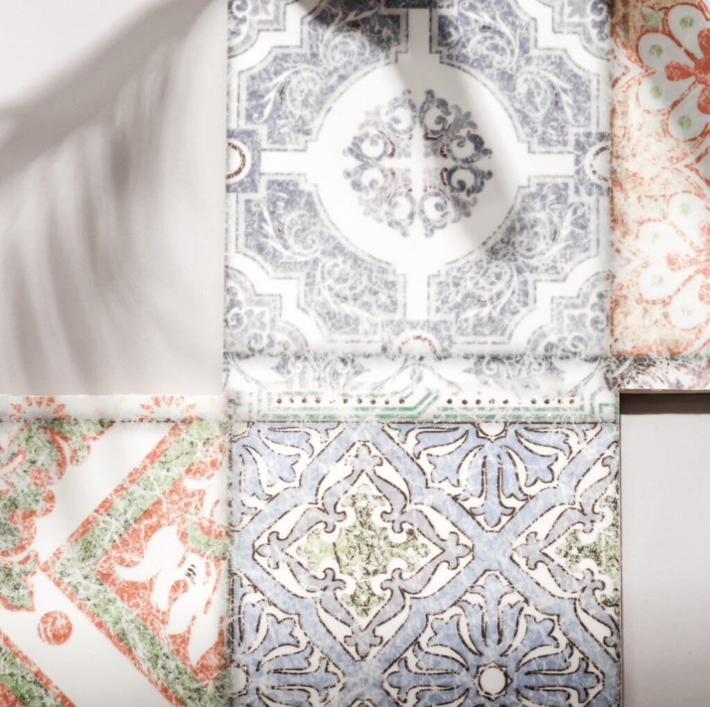 Close-up photo of four decorative fabric pieces with intricate damask patterns in various colors, showcasing their textured and ornate designs.