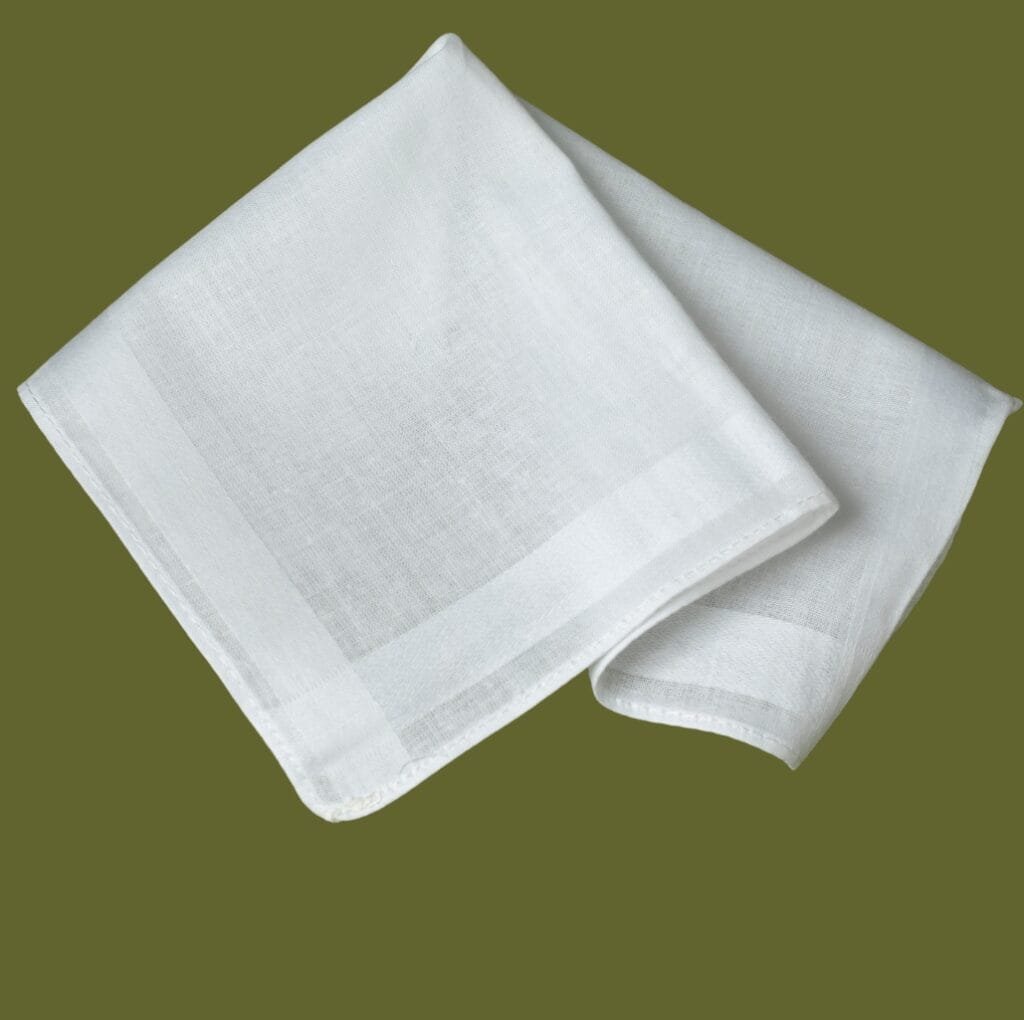A pair of white, translucent handkerchief linen fabric pieces gracefully folded against an olive-green background, showcasing their light, sheer texture.