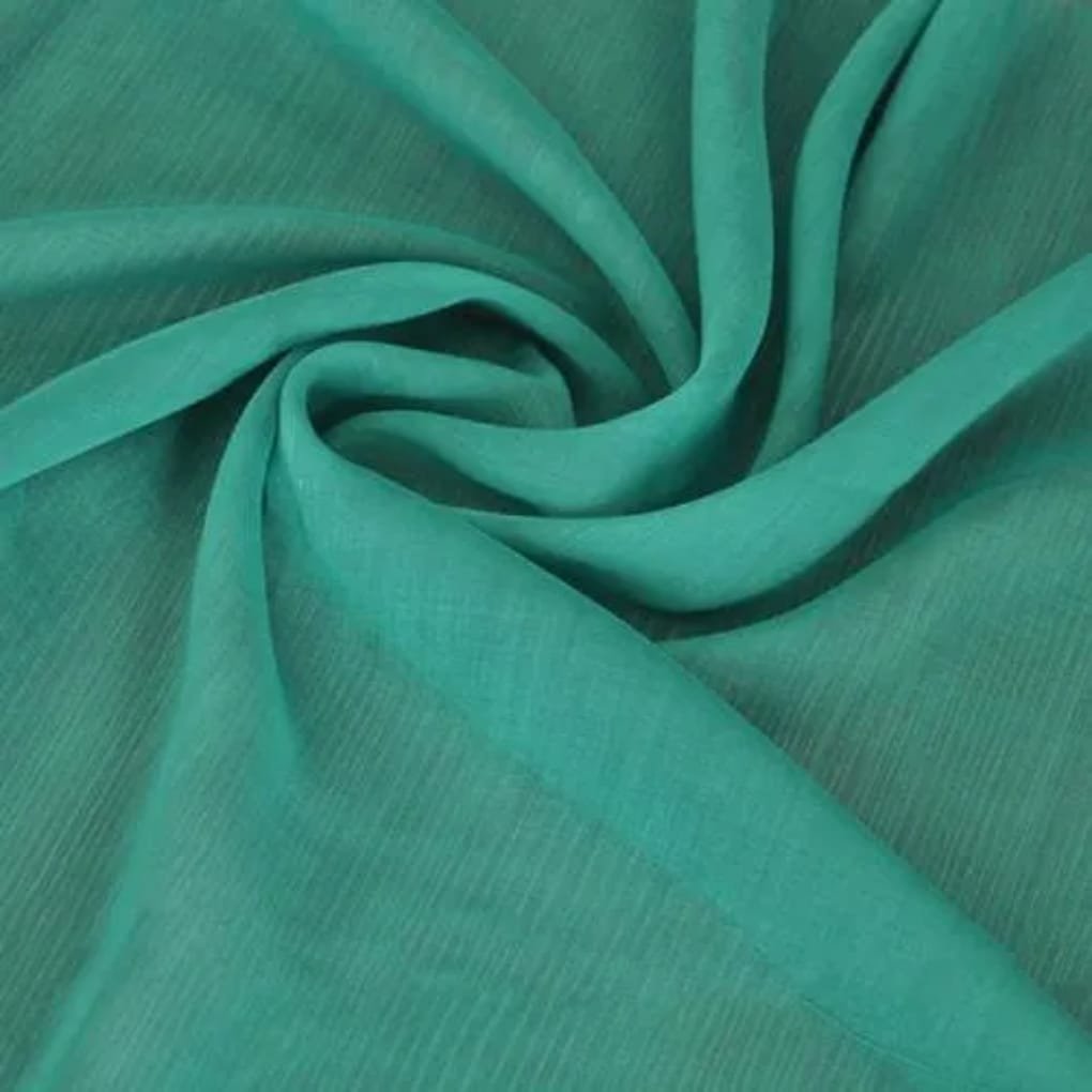 Close-up of bright turquoise fabric with a soft drape and twisting folds, showing a smooth matte to slight sheen.