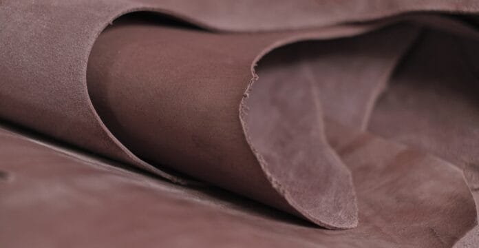 Close-up image of top grain buffalo leather, showing its smooth, natural texture with subtle variations and a soft, matte finish.