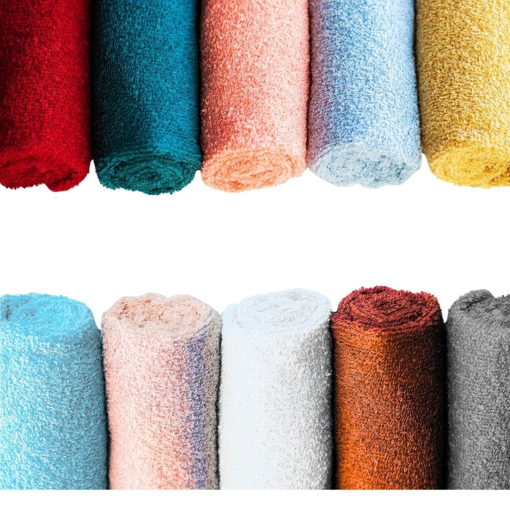Rows of colorful rolled towels in red, teal, peach, light blue, yellow, turquoise, pale peach, light blue, white, brown, and gray.
