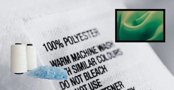 A close-up of a fabric tag that reads “100% POLYESTER” with sewing-related items: two white spools of thread, a small piece of blue shredded material, and a green fabric swatch in a black-framed inset.