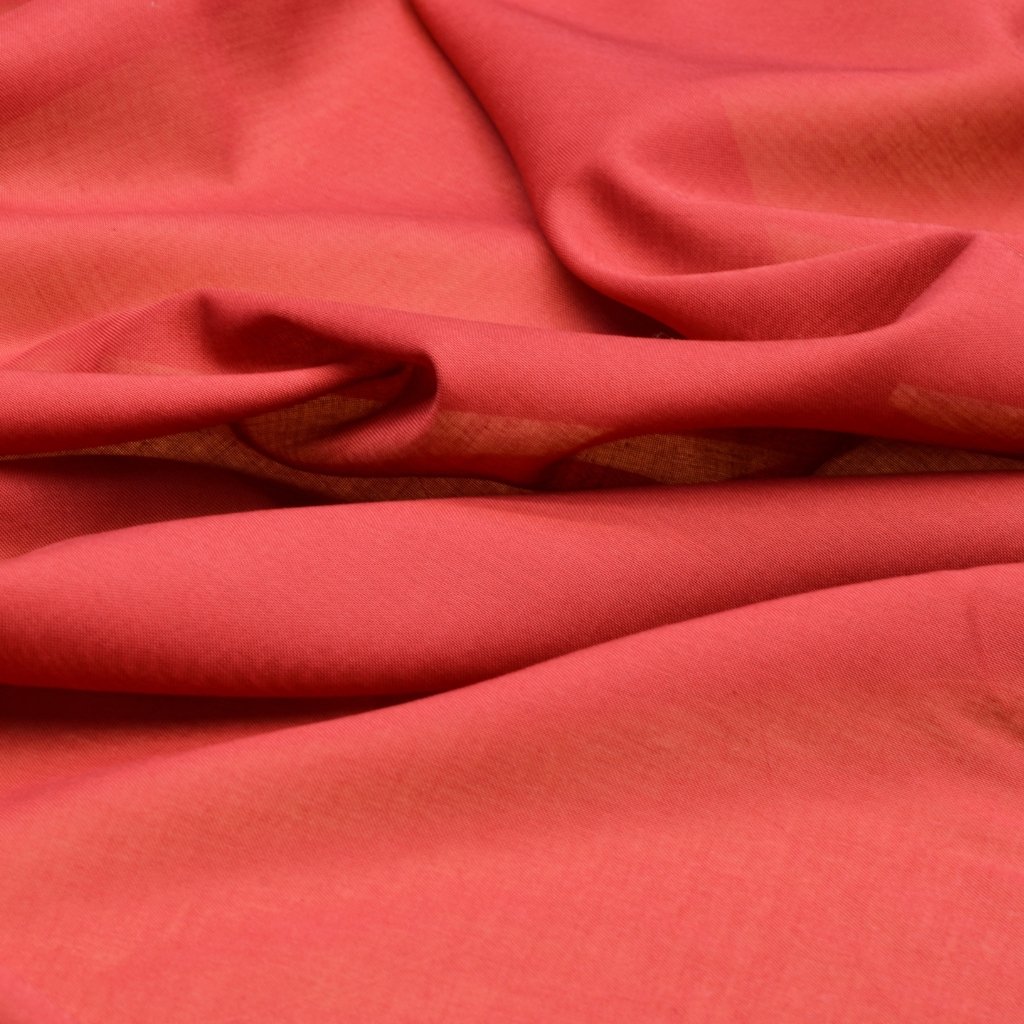A close-up view of soft, wrinkled red fabric or cloth with folds and smooth texture.