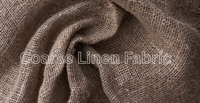 “Close-up view of coarse linen fabric with a loose weave and natural brown-beige color, draped in soft folds.”