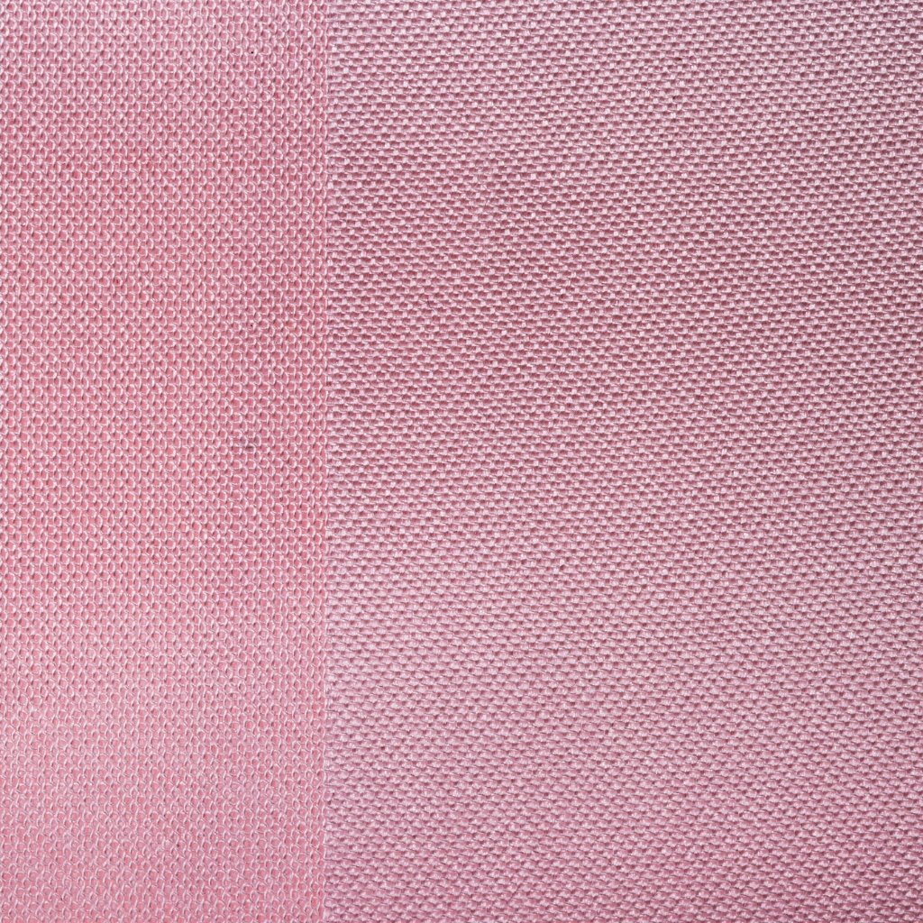 Close-up of pink textured fabric with a subtle woven pattern and a vertical seam running down the center.