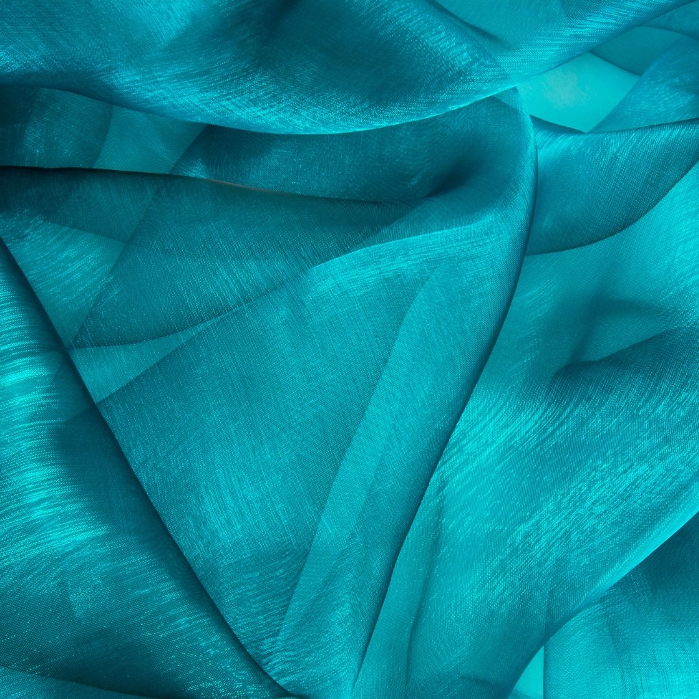 Close-up of teal crushed organza fabric with irregular folds, creating a textured, shimmering surface.