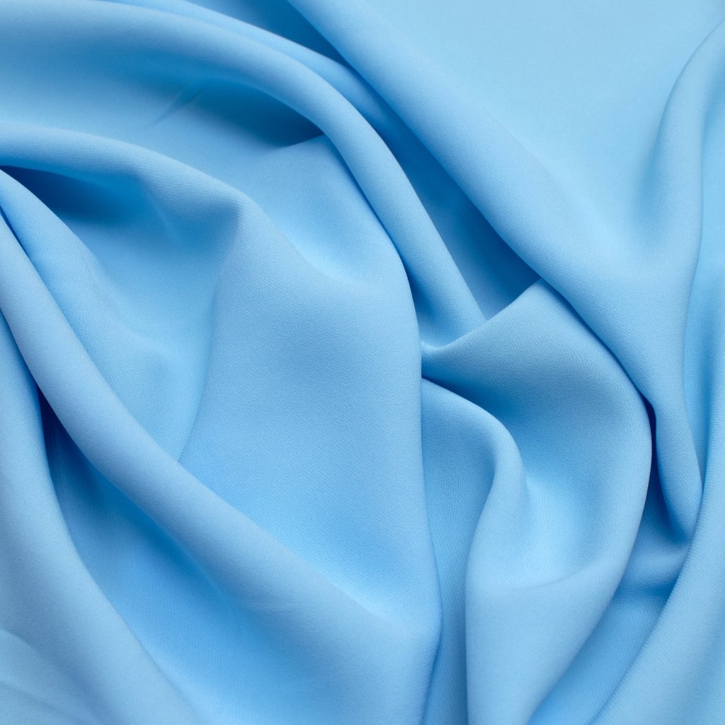 lose-up of soft blue fabric to symbolize viscose rayon, hinting at its smooth texture and drape.
