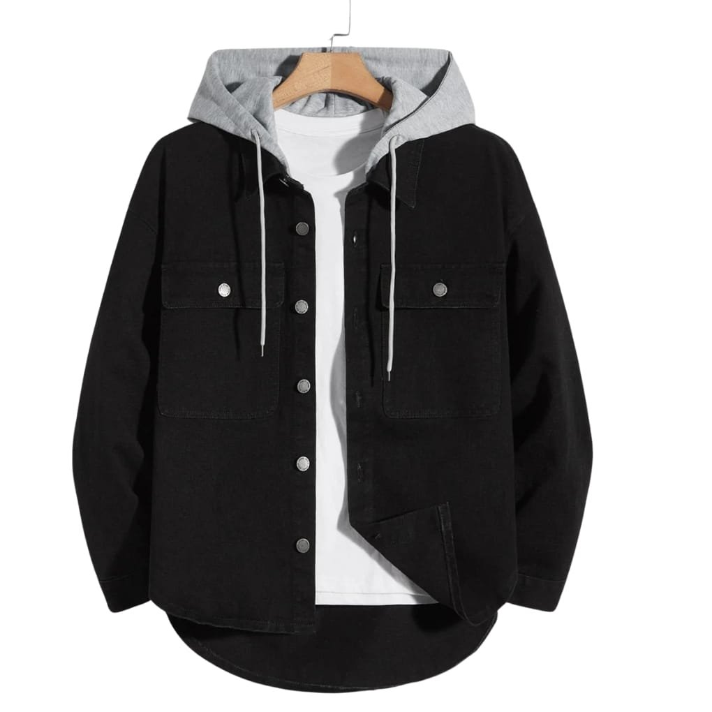A black denim jacket layered over a light gray hoodie, with metal buttons, two chest pockets, and a curved hem showing a white T-shirt underneath.