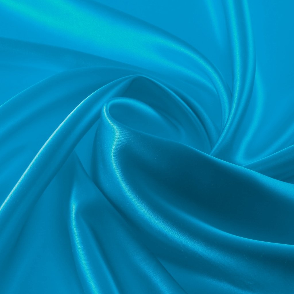A close-up of luxurious satin-organza fabric in bright turquoise, showing smooth, glossy folds and soft reflections that emphasize its silky texture.