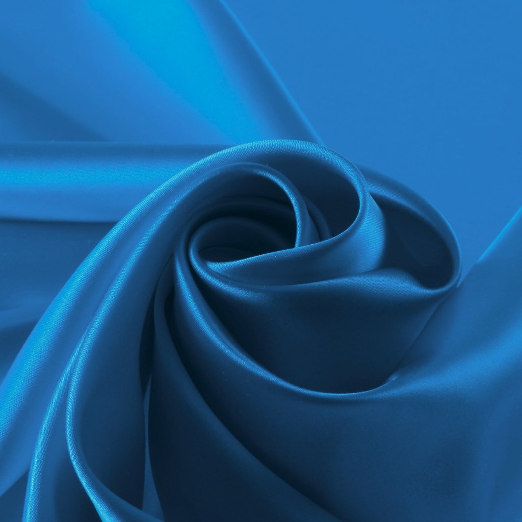 Close-up of satin organza fabric in blue, showcasing glossy sheen and soft folds.