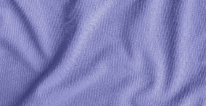 A close-up image of soft purple fabric with gentle folds and a textured weave. jersey cotton fabric