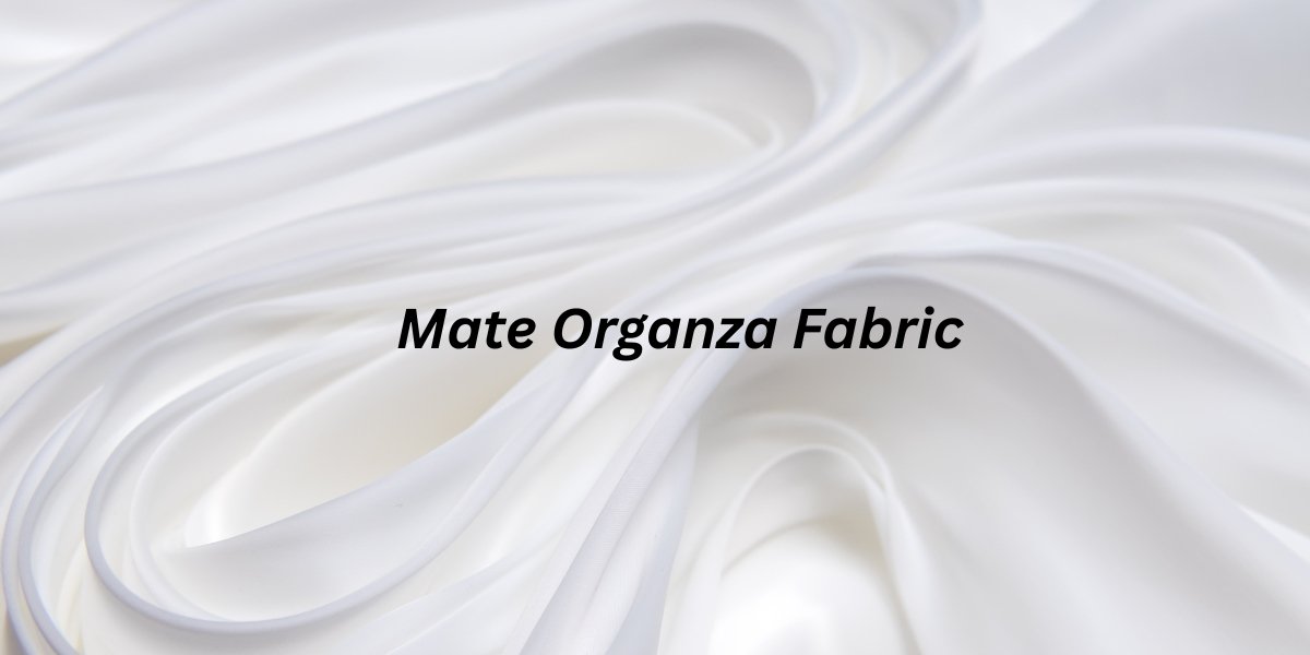 Close-up view of white Mate Organza fabric with soft folds and a smooth matte sheen.