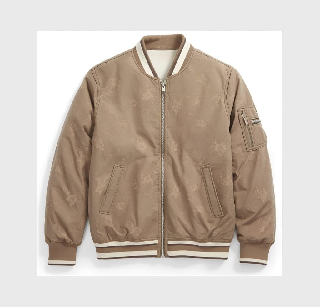 "Tan reversible bomber jacket with a zip front, striped ribbed cuffs and hem, and a zip pocket on the left sleeve. Subtle floral pattern throughout the fabric." Types of Bomber Jackets