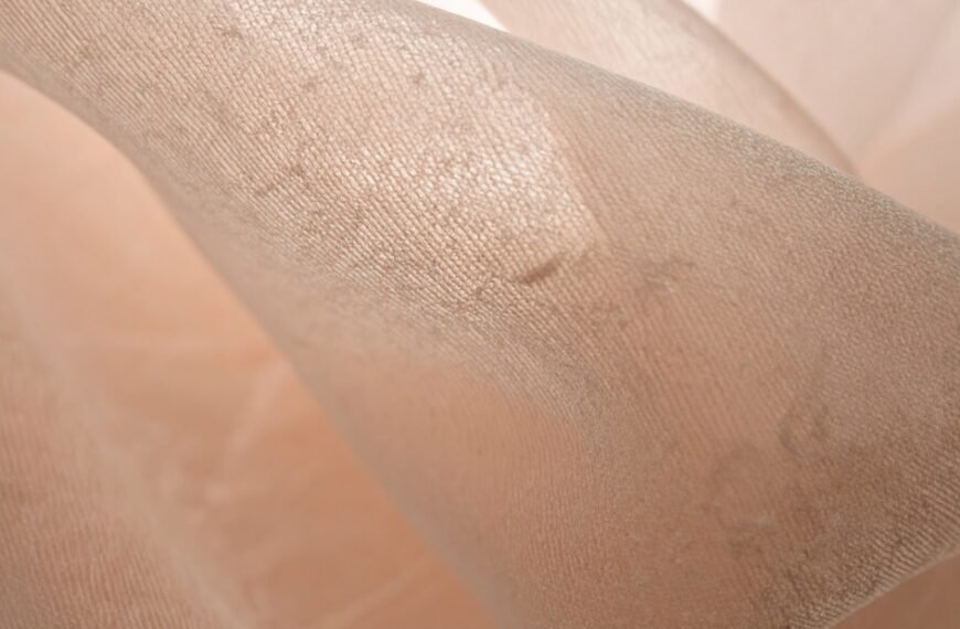 Close-up view of sheer organza fabric with a delicate, translucent weave showing fine threads and subtle sheen. Sheer Organza Fabric