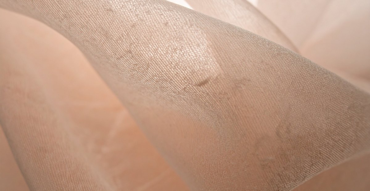 Close-up view of sheer organza fabric with a delicate, translucent weave showing fine threads and subtle sheen. Sheer Organza Fabric