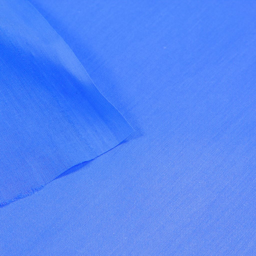 Close-up of vibrant blue fabric with visible stitching and folds. poplin cotton fabric