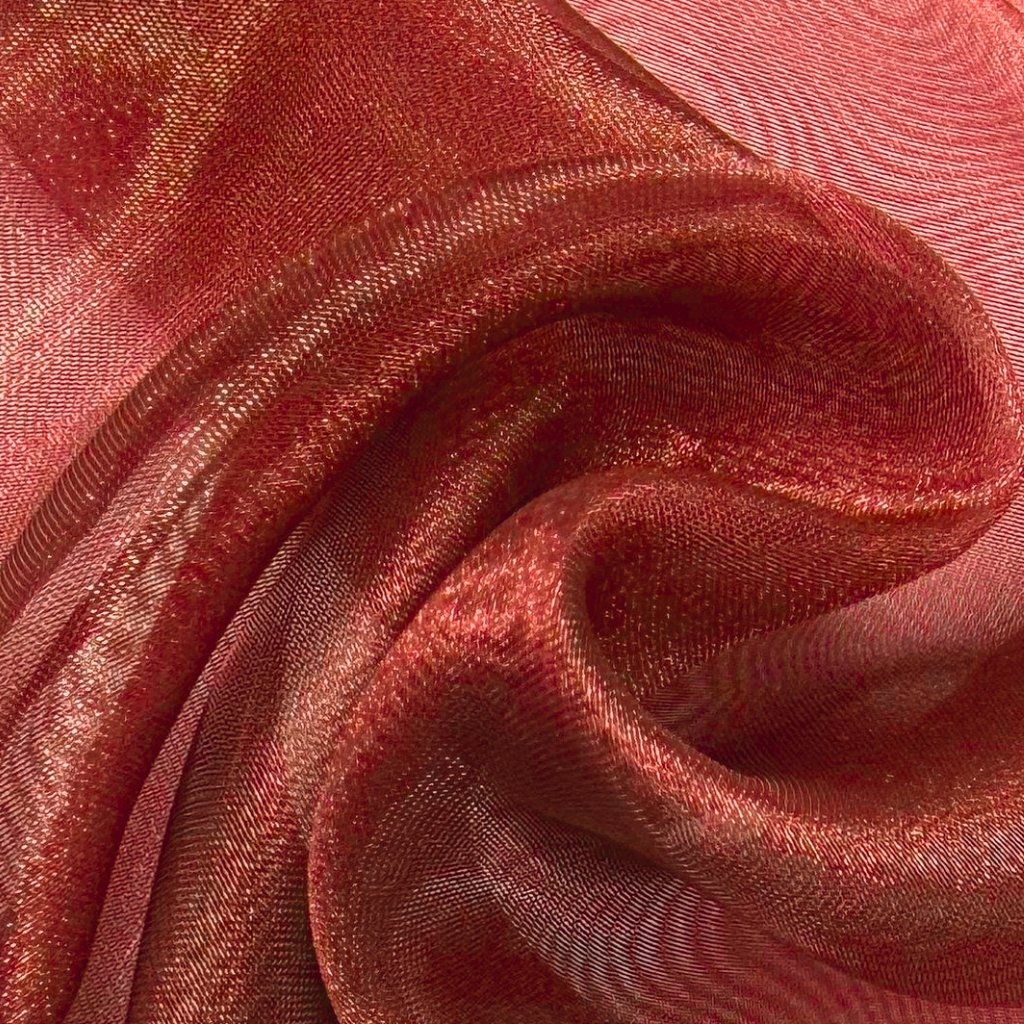 Close-up view of red Polyester Organza fabric with a sheer, crisp texture and subtle shine, showing delicate weave and soft folds."