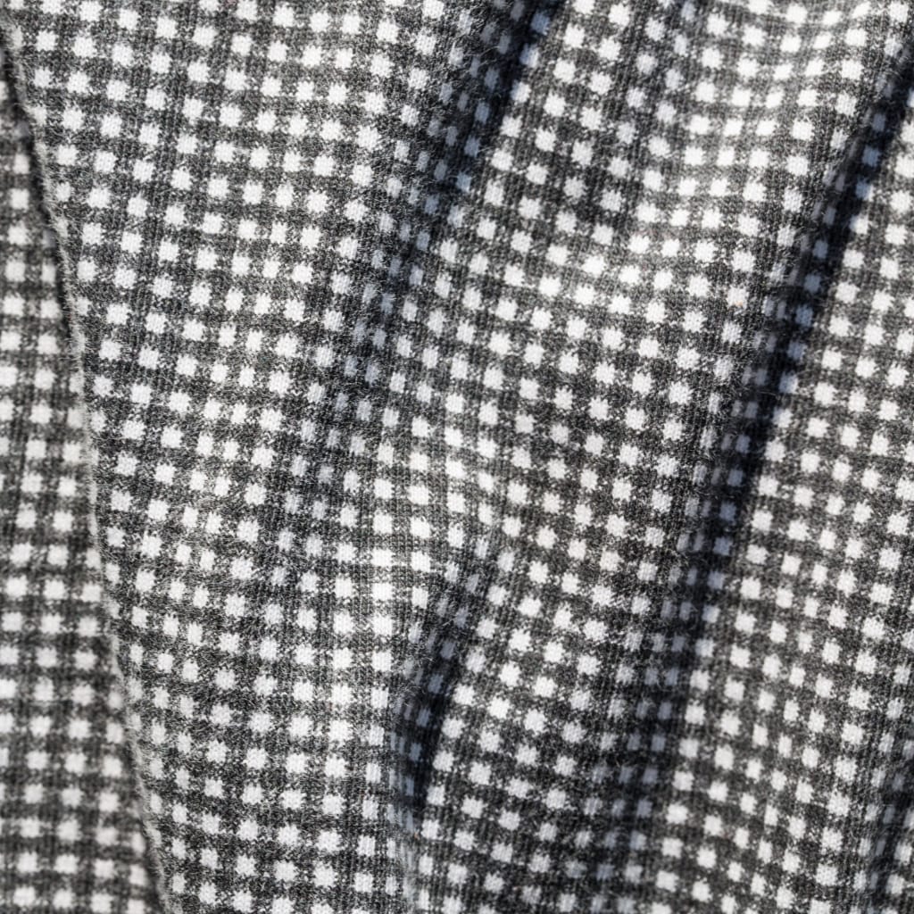 Close-up of a black-and-white checkered fabric with a small square pattern and textured weave.