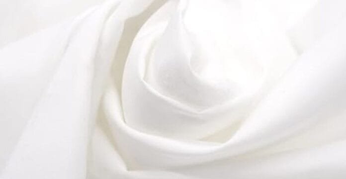 Soft white polyester fabric with smooth folds creating a rose-like swirl pattern.