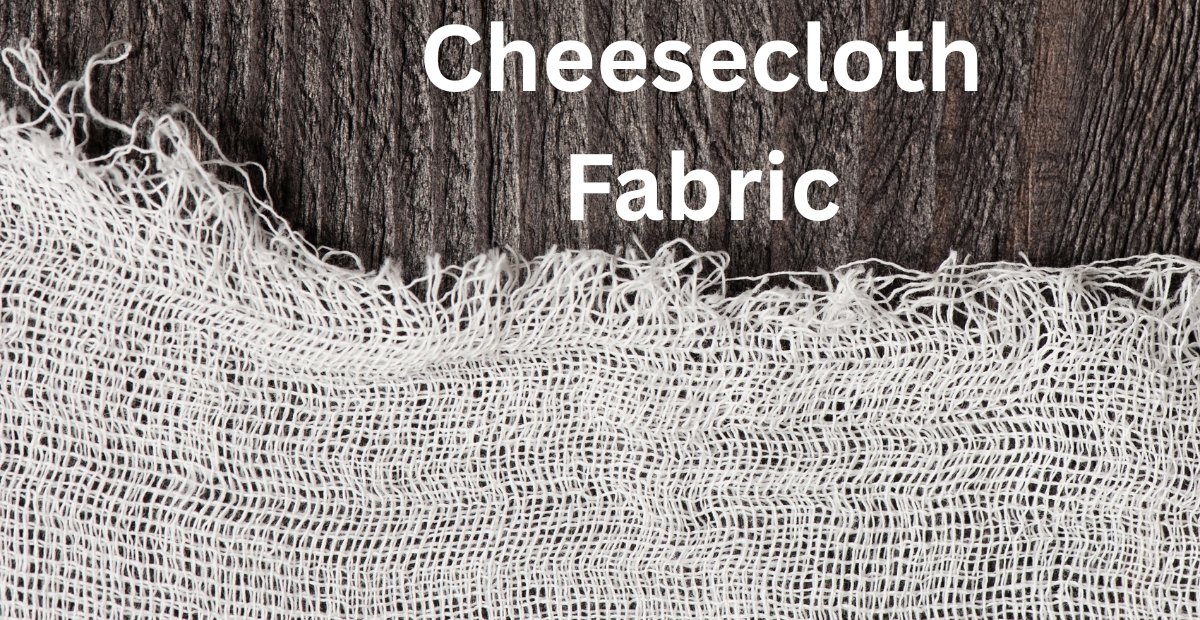 Close-up of a piece of cheesecloth fabric draped over a dark wooden background, showing its loose weave and frayed edges.