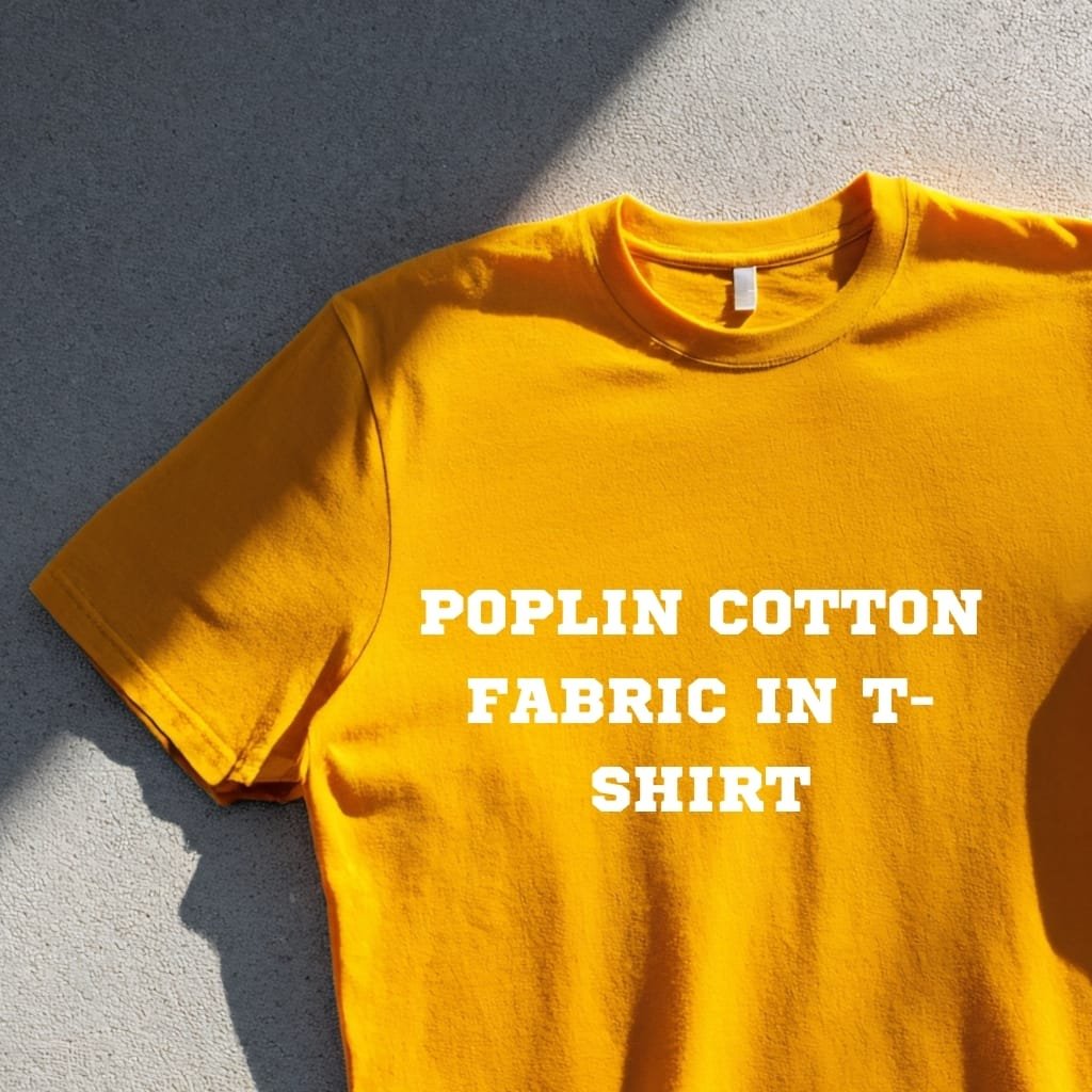 Bright yellow T-shirt with white bold text reading 'POPLIN COTTON FABRIC IN T-SHIRT' on a light concrete background.