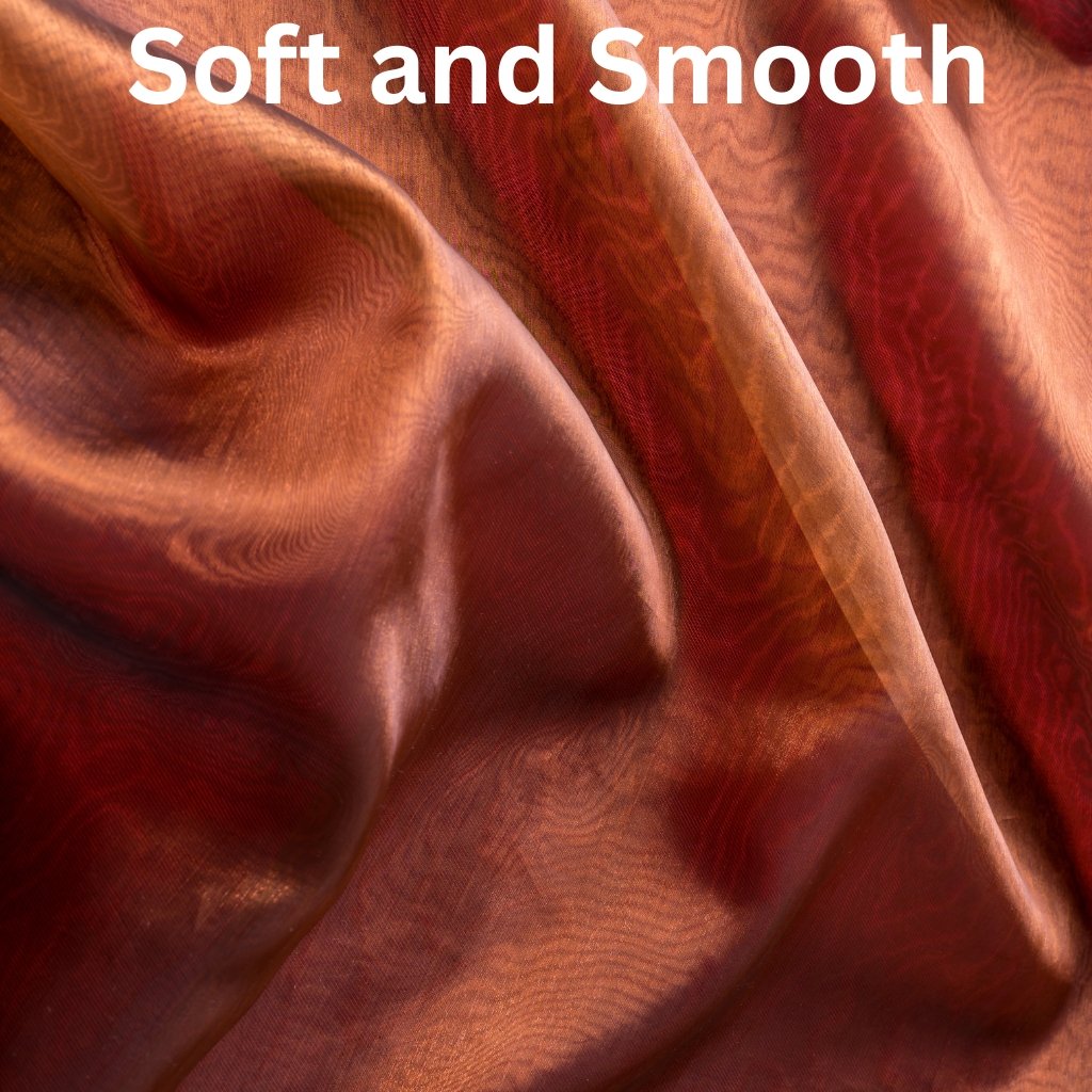Close-up of luxurious, silky fabric in warm copper and bronze tones with gentle folds; the words 'Soft and Smooth' appear at the top.